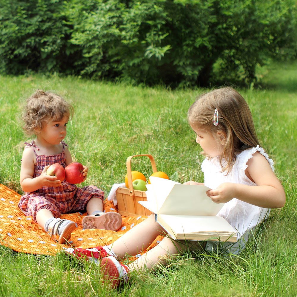 Child enjoying an outdoor story picnic.